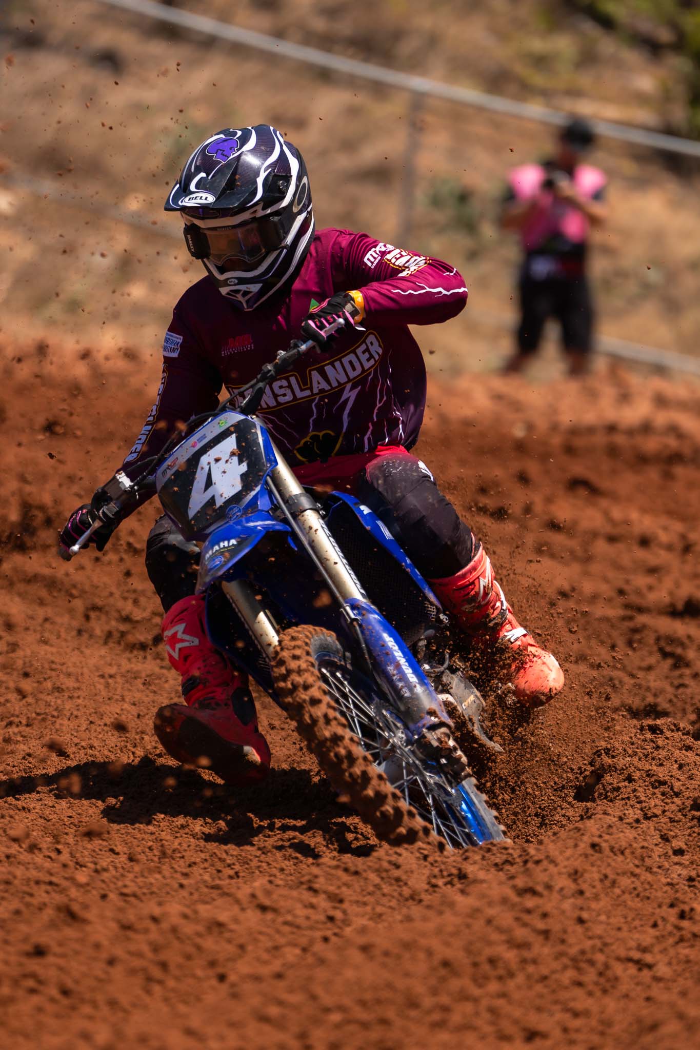 Queensland motocross rider corners through deep red dirt, spraying soil from the rear wheel at MXGP of Australia.